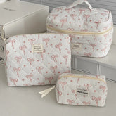 1PC Pink Strawberry Women Cosmetic Quilted Bag with pink bow designs and zipper closures, perfect for cosmetic storage.