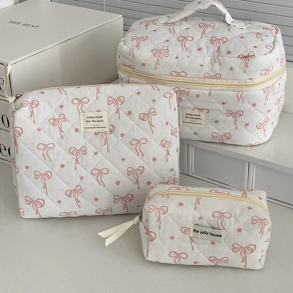 1PC Pink Strawberry Women Cosmetic Quilted Bag with pink bow designs and zipper closures, perfect for cosmetic storage.