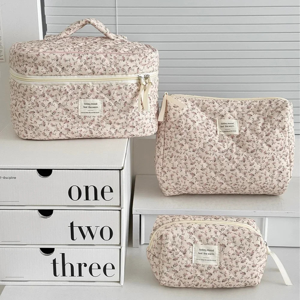 1PC Pink Strawberry Women Cosmetic Quilted Bag displayed in three sizes on a white shelf with storage boxes.