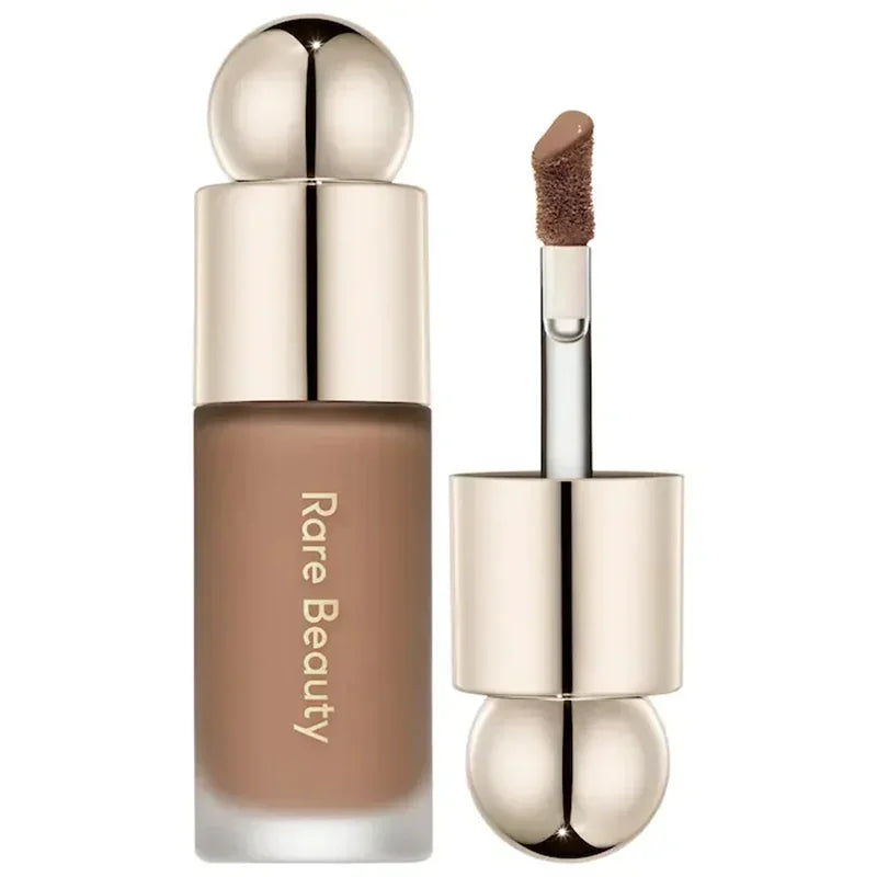Rare Beauty Liquid Blush with applicator in a sleek container, showcasing its lightweight formula for a natural glow.